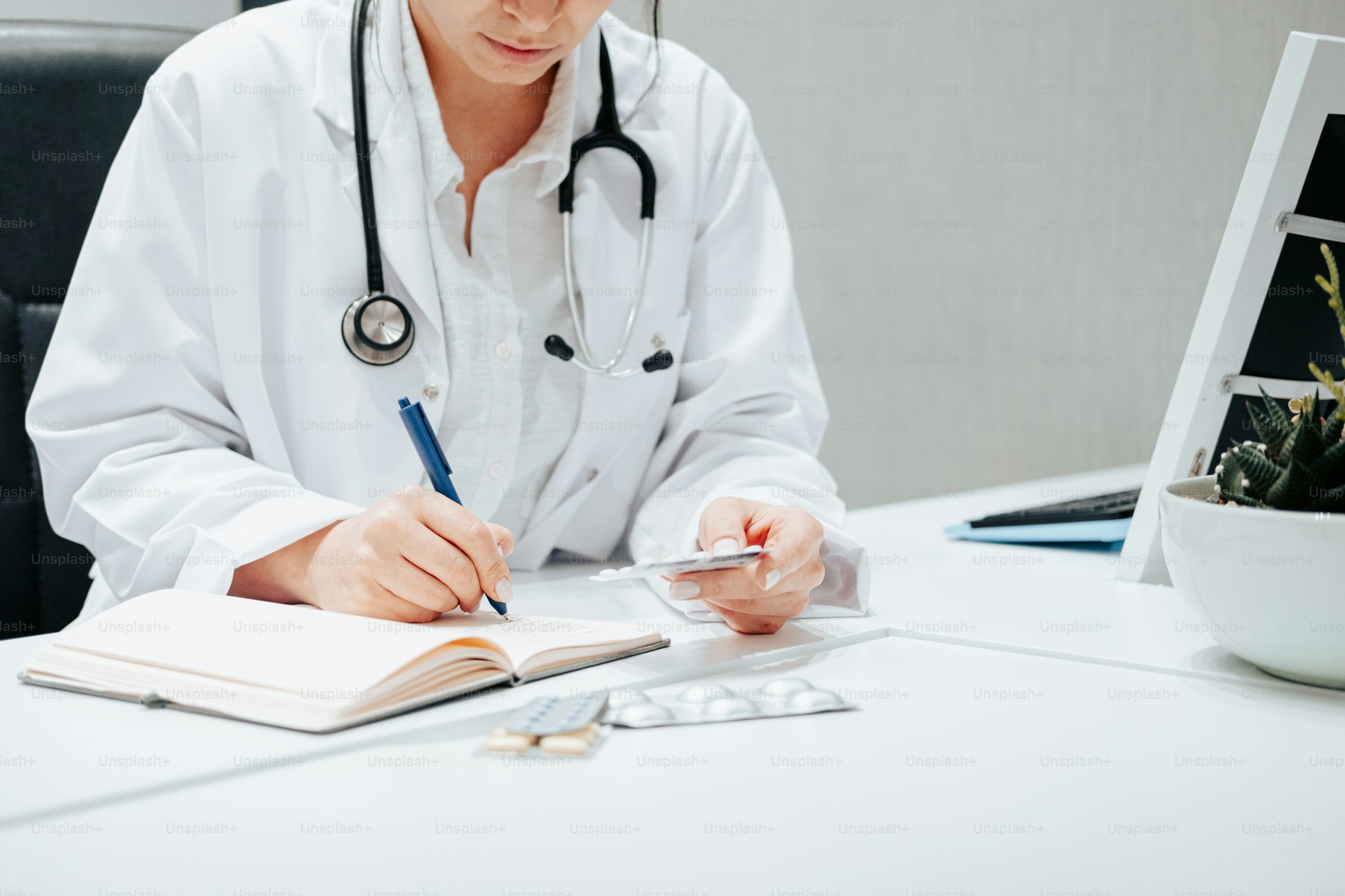 Doctor writing prescription at GP practice in Gatesville Cape Town